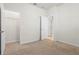 Bedroom featuring neutral carpet, closet doors, and natural lighting at 7343 Oakmoss Loop, Davenport, FL 33837