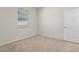 Bright bedroom with neutral carpet, natural light, and a closet door at 7343 Oakmoss Loop, Davenport, FL 33837