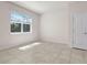 Well-lit bedroom with tile floors, a window with blinds, and a closet door at 7343 Oakmoss Loop, Davenport, FL 33837