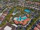High-angle view of a community offering resort-style amenities including pools, tennis courts, and tropical landscaping at 7343 Oakmoss Loop, Davenport, FL 33837