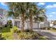 Well-maintained home with two-car garage, brick paved driveway and palm trees in the front yard at 7343 Oakmoss Loop, Davenport, FL 33837