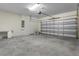 Spacious garage with gray concrete floor and white walls with a work bench at 7343 Oakmoss Loop, Davenport, FL 33837