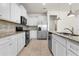 Modern kitchen featuring stainless steel appliances, granite countertops, and tiled backsplash at 7343 Oakmoss Loop, Davenport, FL 33837