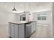 Kitchen island with granite countertops, stainless steel dishwasher, and pendant lighting at 7343 Oakmoss Loop, Davenport, FL 33837