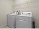 Laundry room with washer and dryer and wire shelving at 7343 Oakmoss Loop, Davenport, FL 33837