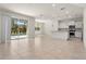 Open-concept living space flows into the kitchen, with sliding doors that offer a pool view at 7343 Oakmoss Loop, Davenport, FL 33837