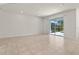 Bright living space with tile floors and sliding glass doors that lead to an outdoor space at 7343 Oakmoss Loop, Davenport, FL 33837