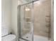 Shower with tile walls and sliding glass doors at 7343 Oakmoss Loop, Davenport, FL 33837