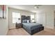 A serene bedroom with a plush bed, neutral tones, and a large window for natural light at 9023 Dogleg Dr, Davenport, FL 33896