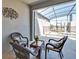 An outdoor patio with comfortable seating, a table, and a screened pool enclosure for relaxation at 9023 Dogleg Dr, Davenport, FL 33896