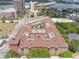 Stunning aerial view of a modern apartment complex featuring a unique rooftop design and surrounding cityscape views at 911 N Orange Ave # 352, Orlando, FL 32801