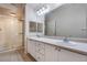 Well-lit bathroom with double sinks and a glass-enclosed shower at 911 N Orange Ave # 352, Orlando, FL 32801