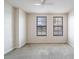 A spacious bedroom features two windows with neutral walls, carpet flooring and a ceiling fan at 911 N Orange Ave # 352, Orlando, FL 32801