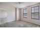 Sunlit bedroom offers large windows with a pleasant view and neutral carpet at 911 N Orange Ave # 352, Orlando, FL 32801