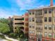 Exterior view featuring balconies, assigned covered parking, and attractive architecture at 911 N Orange Ave # 352, Orlando, FL 32801