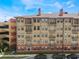 Close-up exterior of a multi-story building with balconies, and a parking garage on the left at 911 N Orange Ave # 352, Orlando, FL 32801