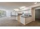 Open-concept kitchen features modern white cabinetry, granite countertops, and convenient breakfast bar at 911 N Orange Ave # 352, Orlando, FL 32801