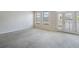 Sun-filled living room has neutral walls and balcony with multiple windows providing natural light at 911 N Orange Ave # 352, Orlando, FL 32801