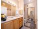 Bathroom with light wood cabinets and a shower/tub at 9141 Lee Vista Blvd # 305, Orlando, FL 32829