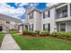 Two-story townhome with landscaping and a walkway at 9141 Lee Vista Blvd # 305, Orlando, FL 32829