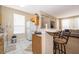 Kitchen with light wood cabinets and a breakfast bar at 9141 Lee Vista Blvd # 305, Orlando, FL 32829