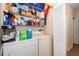Well-equipped laundry room with washer, dryer, and ample storage shelving at 9141 Lee Vista Blvd # 305, Orlando, FL 32829
