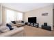 Living room with beige couches and a large TV at 9141 Lee Vista Blvd # 305, Orlando, FL 32829