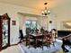 Formal dining area featuring a wooden table set, a decorative rug, and natural light from a bright window at 9145 Floribunda Dr, Orlando, FL 32818