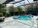 Backyard screened-in pool and spa with a waterfall feature, surrounded by tropical plants at 9145 Floribunda Dr, Orlando, FL 32818