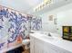 Bathroom featuring vanity sink with drawers and a shower with a decorative curtain at 9263 Lake Lotta Cir, Gotha, FL 34734