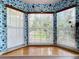 Charming bay window area with colorful patterned walls, hardwood floors, and serene outdoor views at 9263 Lake Lotta Cir, Gotha, FL 34734