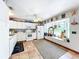 Well-lit kitchen featuring a window seat, white appliances, and stylish decorations at 9263 Lake Lotta Cir, Gotha, FL 34734