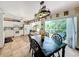 Open-concept kitchen and dining area with access to the deck and a large dining table at 9263 Lake Lotta Cir, Gotha, FL 34734