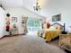 Spacious main bedroom with vaulted ceiling, chandelier, and access to a private balcony at 9263 Lake Lotta Cir, Gotha, FL 34734