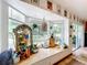 Charming window seat area with plants and decor, offering serene views of the backyard at 9263 Lake Lotta Cir, Gotha, FL 34734