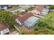 Aerial view of house with screened pool, fenced yard, and mature trees at 9664 Lake Douglas Pl, Orlando, FL 32817
