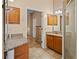 Bathroom featuring granite counters, a glass-door shower, and tile flooring at 9664 Lake Douglas Pl, Orlando, FL 32817