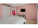 Cozy bedroom featuring a decorative wrought iron bed frame, a TV, and a closet at 9664 Lake Douglas Pl, Orlando, FL 32817