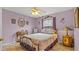 Bedroom featuring a lilac color scheme, an ornate bed, and traditional decor at 9664 Lake Douglas Pl, Orlando, FL 32817