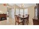 Elegant dining room with ornate chandelier, traditional wooden table, and abundant natural light at 9664 Lake Douglas Pl, Orlando, FL 32817