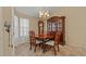 Formal dining room featuring a classic chandelier, wooden table set, and a charming china cabinet at 9664 Lake Douglas Pl, Orlando, FL 32817