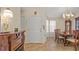 Inviting foyer with white front door, elegant lighting, and decorative furnishings that complement the dining area at 9664 Lake Douglas Pl, Orlando, FL 32817