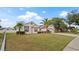 Well-maintained single Gathering home with lush green lawn and driveway leading to an attached two-car garage at 9664 Lake Douglas Pl, Orlando, FL 32817