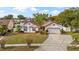 Charming single-Gathering home with a well-kept lawn, mature landscaping, and an attached two-car garage at 9664 Lake Douglas Pl, Orlando, FL 32817