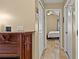 Hallway view leading to a bedroom, featuring tiled floors, neutral walls, and access to the front of the house at 9664 Lake Douglas Pl, Orlando, FL 32817