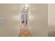 Neutral hallway featuring tile flooring, leading to rooms with unique decor at 9664 Lake Douglas Pl, Orlando, FL 32817