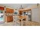 Cozy eat-in kitchen featuring a large island, stainless steel appliances, oak cabinets, and pool access at 9664 Lake Douglas Pl, Orlando, FL 32817