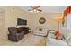 Spacious living room with tile floors, a TV, and comfortable seating at 9664 Lake Douglas Pl, Orlando, FL 32817