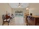 Bright living room with a piano, sliding glass doors to the pool, and elegant furnishings at 9664 Lake Douglas Pl, Orlando, FL 32817