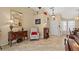 Open-concept living room featuring neutral decor, tile flooring, a decorative fireplace, and plenty of natural light at 9664 Lake Douglas Pl, Orlando, FL 32817
